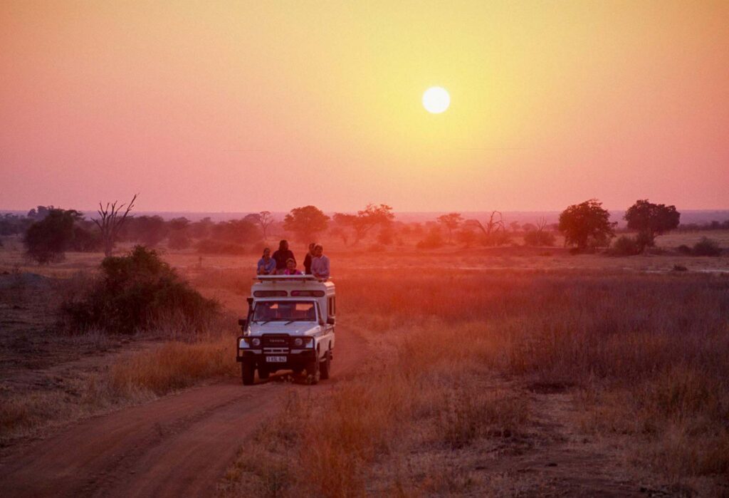 Safari vehicle parked at sunset in Ruaha National Park, Tanzania, 1997