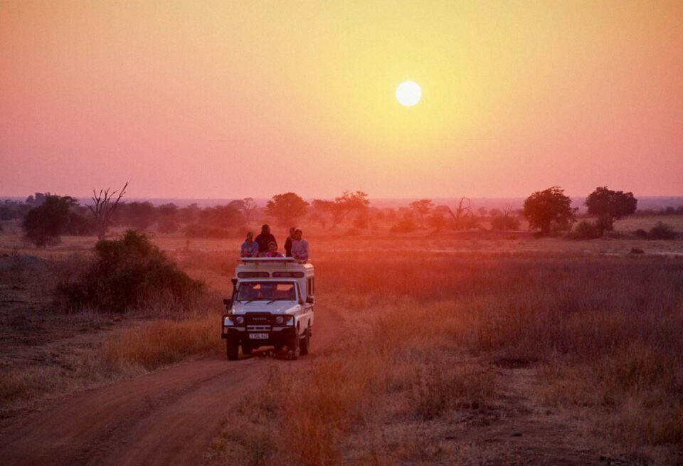 Safari vehicle parked at sunset in Ruaha National Park, Tanzania, 1997
